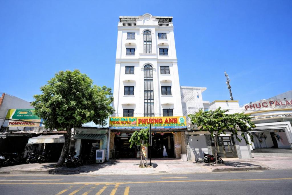 a white building on a city street with shops at Phương Anh 9 Hotel in Da Nang