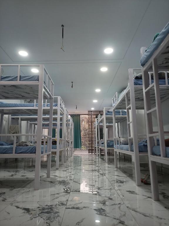 a room with several bunk beds and a hallway at Leesha Tower - Dormitory in Jhānsi