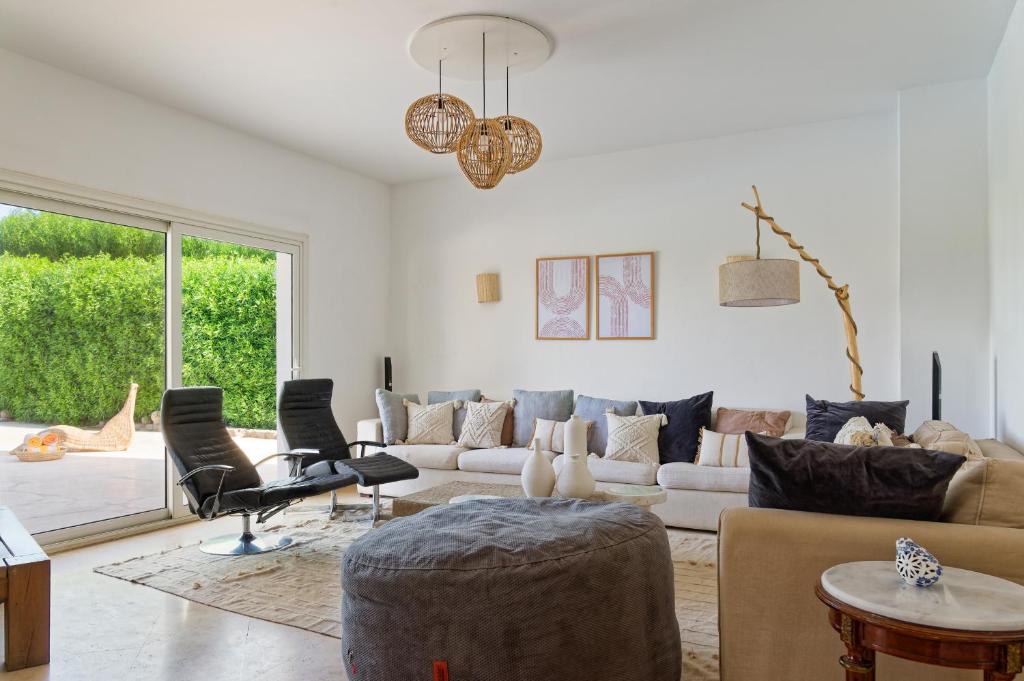 a living room with a couch and chairs at VESTA - El Gouna Residence in Hurghada