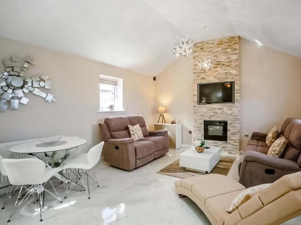 a living room with a couch and a table at Peewit Cottage-Ukc6986 in Castleside
