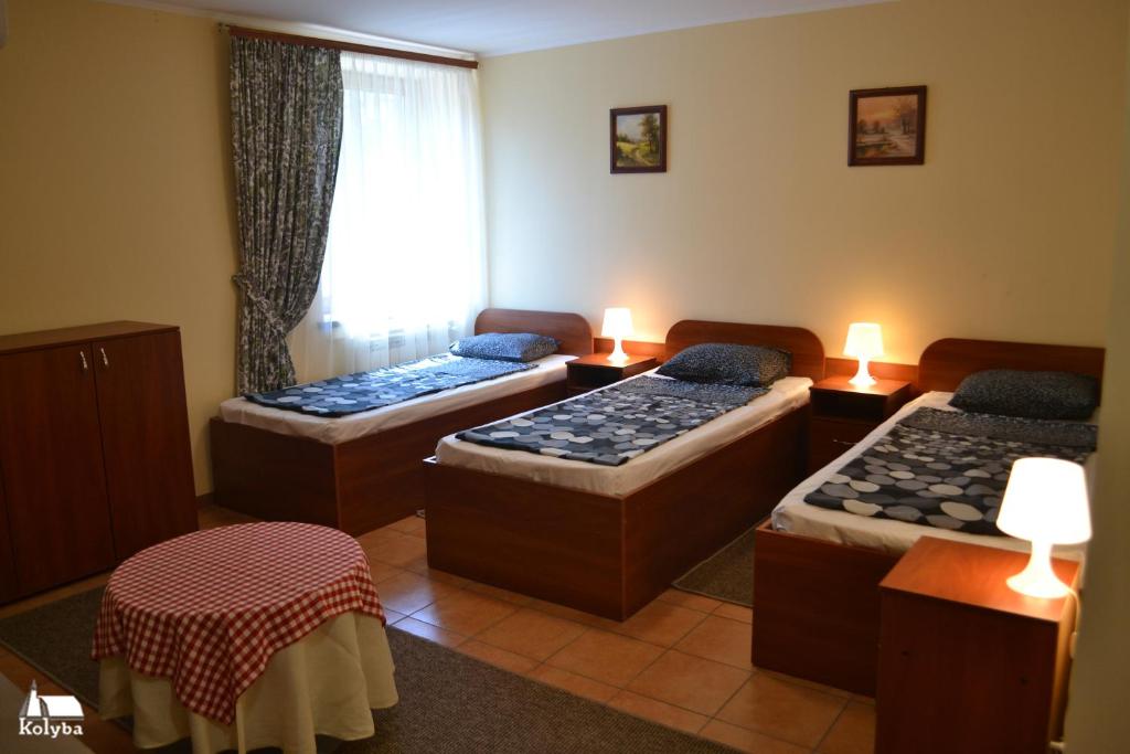 Postel nebo postele na pokoji v ubytování Zakarpatska Kolyba