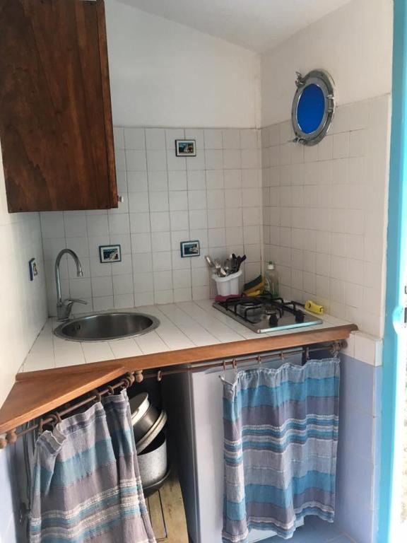 a kitchen with a sink and a counter top at Azzurromare Residence in Procida