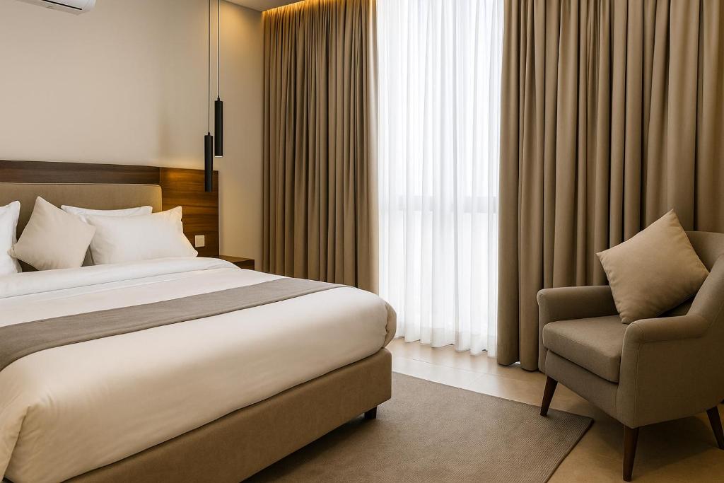 a hotel room with a bed and a chair at Alpirious in Islamabad