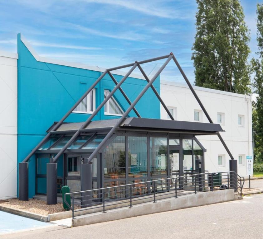 a building with a large metal structure at Kyriad ECO - Moulins Sud Yzeure in Moulins