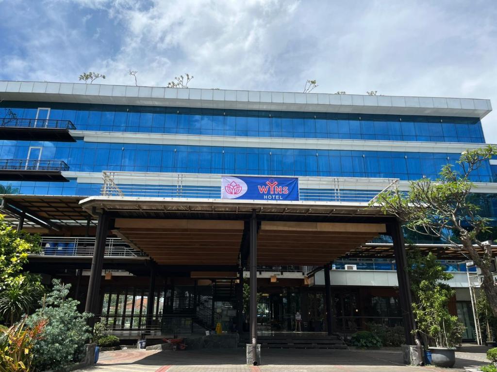 a blue building with a sign in front of it at WYNS Hotel Bandung in Bandung