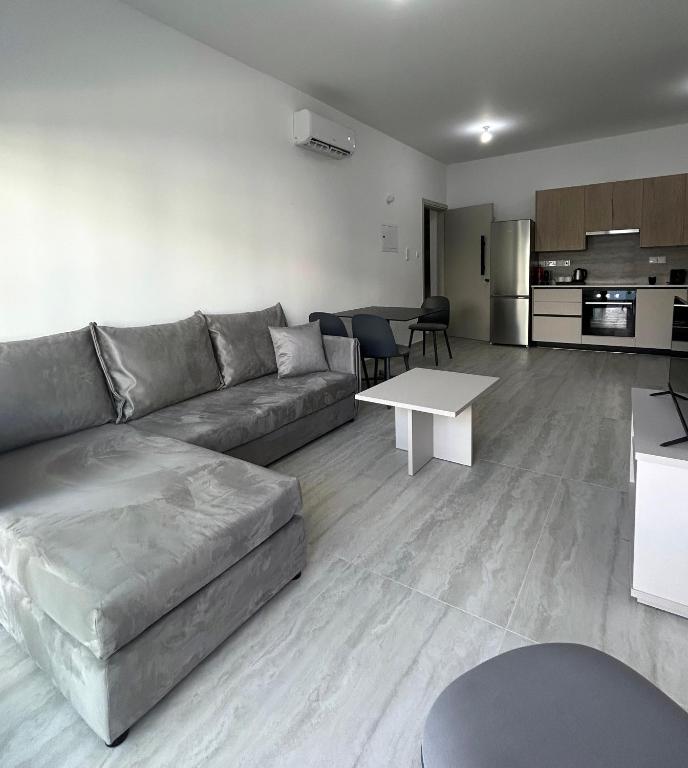 a living room with a couch and a table at AFRODITI Living in Nicosia
