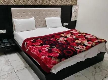 a bed with a bunch of red roses on it at Hotel Ravi Residency in Jalandhar