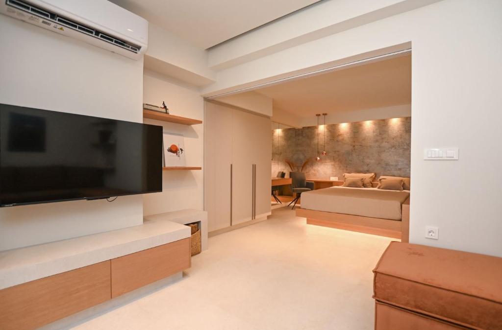 a living room with a large flat screen tv at Elvira's Apartments in Kalymnos