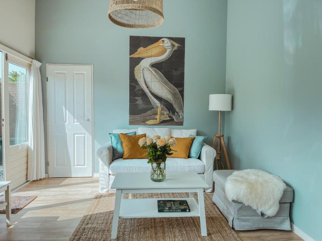a living room with a bird painting on the wall at The Pelican in Warmenhuizen