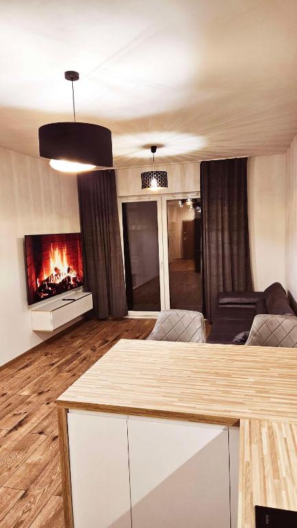 a living room with a couch and a fireplace at GOLD APARTAMENT Ząbki in Ząbki