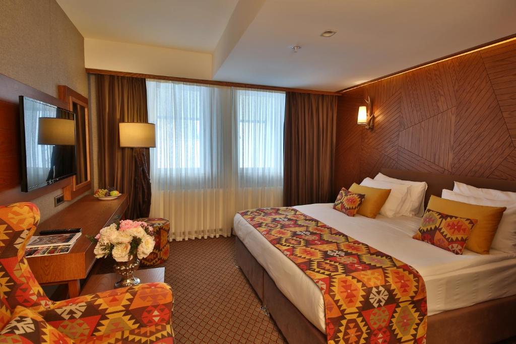 Кровать или кровати в номере Bof Hotels Uludağ Ski&Luxury Resort All Inclusive