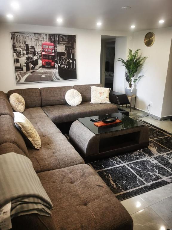 a living room with a couch and a red double decker bus at Nordic Elegance Villa in Uddevalla