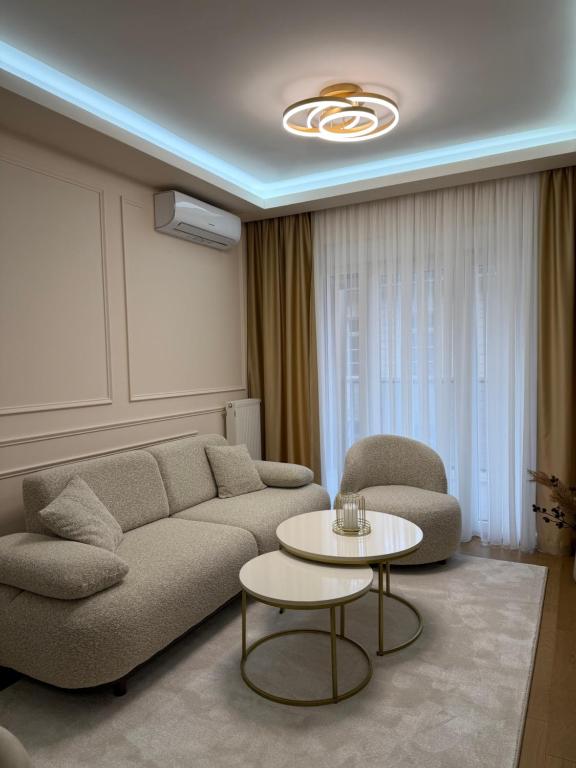 a living room with a couch and a table at Palata Royal Banja Luka Luxury Apartment in Banja Luka
