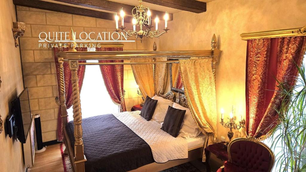 a bedroom with a canopy bed and a window at Rezidence Zámeček - Boutique Hotel in Františkovy Lázně