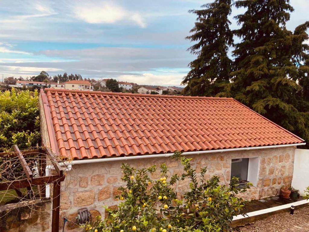 a small house with an orange tile roof at Casa Água 