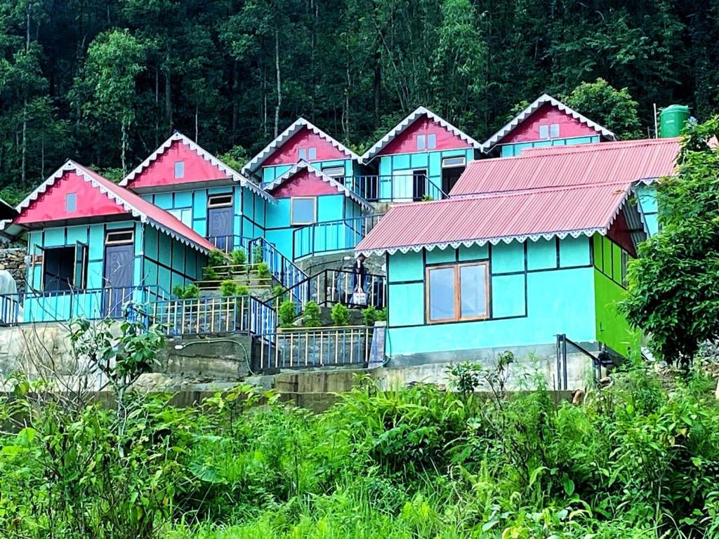 a row of houses with pink and blue at Kanchenjunga Vista Pabong in Sāmthar