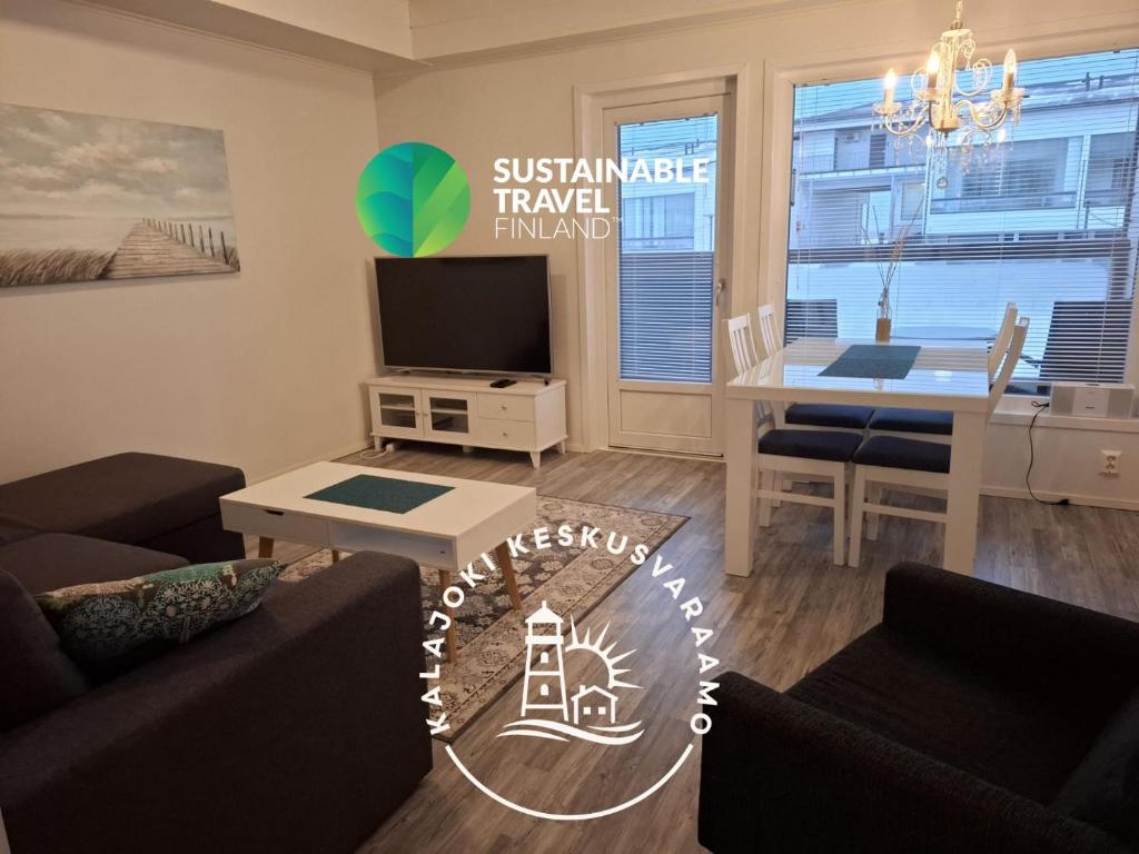 a living room with a couch and a table and a dining room at Starvillas B201 in Kalajoki