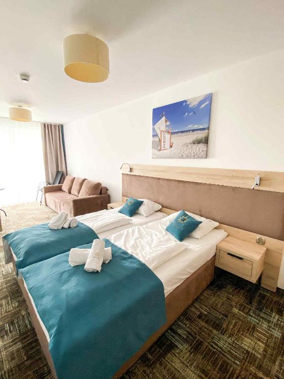 una camera d'albergo con due letti con asciugamani sopra di Apartament 301 Casa Bahia a Grzybowo