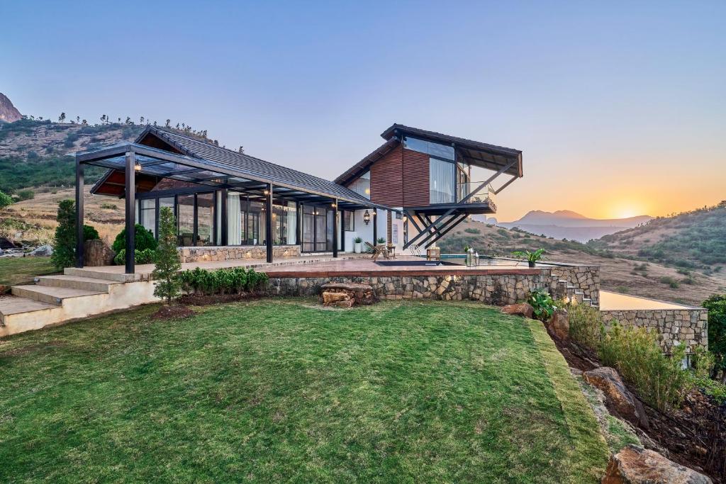 a house with a view of the mountains at SaffronStays Villa Reya in Trimbak