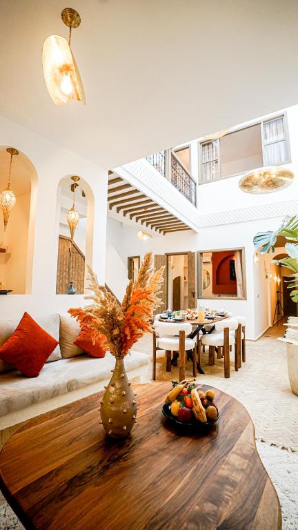 a living room with a couch and a table at Riad Alaya, Rooftop Pool & Koutoubia View in Marrakesh