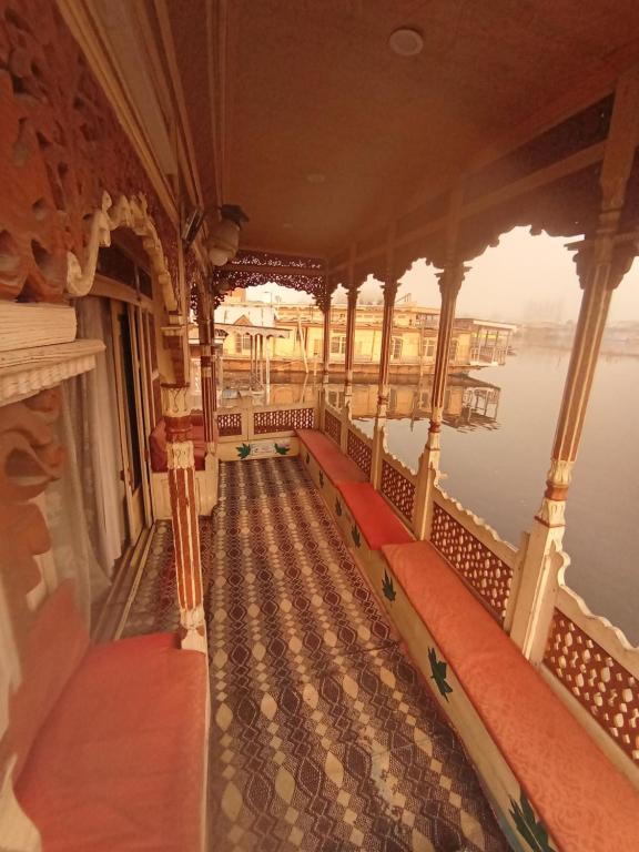 a balcony on a boat on the water at Heide houseboats in Srinagar