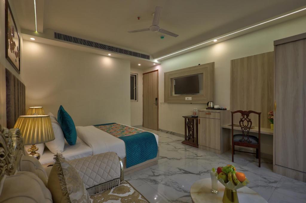 a hotel room with a bed and a television at Hotel East End Delhi Airport in New Delhi