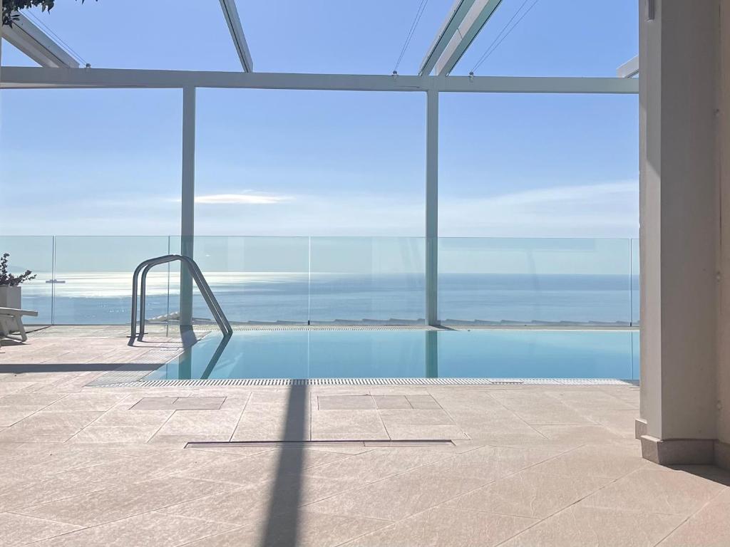 een zwembad met een glijbaan in een gebouw bij MEDITERRANEAN SEASONS, VILLA MEDITERRANEA Taormina, Private Pool & Sea View in Taormina