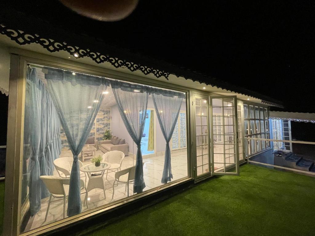 a room with a balcony with a table and chairs at Countryside Retreat in Pune