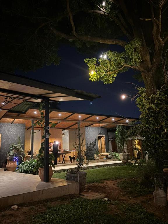 a house with a patio at night at Terra Bella in Fernando de la Mora
