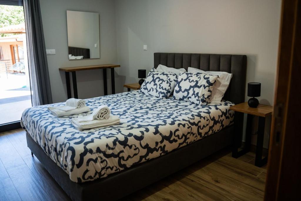 a bedroom with a bed with two towels on it at Casa da Boucinha in Celorico de Basto