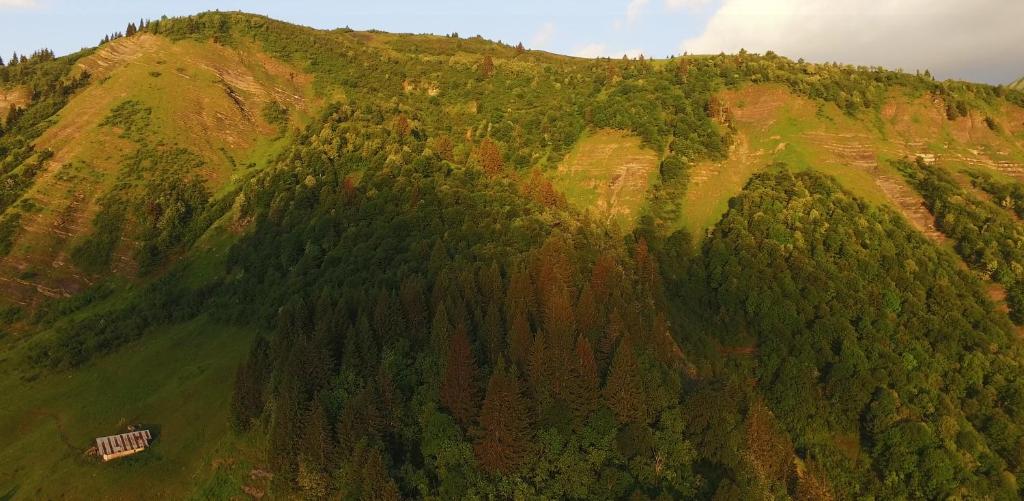 an aerial view of a mountain with a house on it at Cabane entre terre et ciel in Saint-Nicolas-la-Chapelle