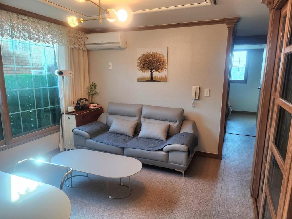 a living room with a couch and a table at Hanok Story in Jeonju