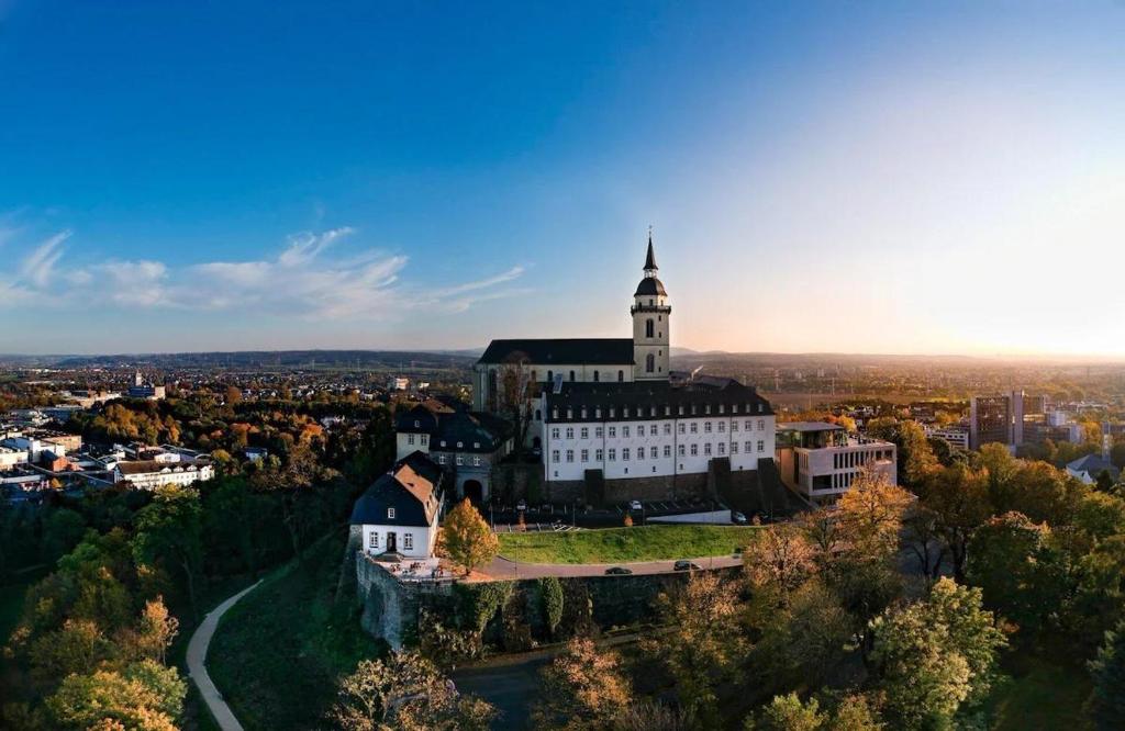 an aerial view of a building with a tower at Souterrain Casa Siegburg in Siegburg