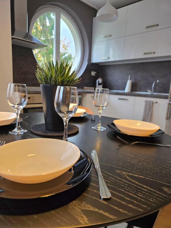 a table with plates and wine glasses on it at APart Residence Shumen in Shumen