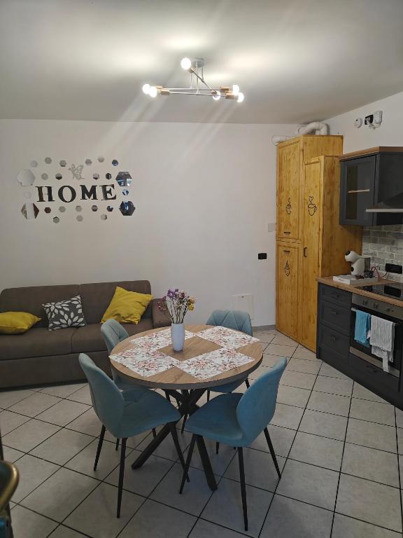 ein Wohnzimmer mit einem Tisch und blauen Stühlen in der Unterkunft Bilocale vacanze in Borgo Ticino