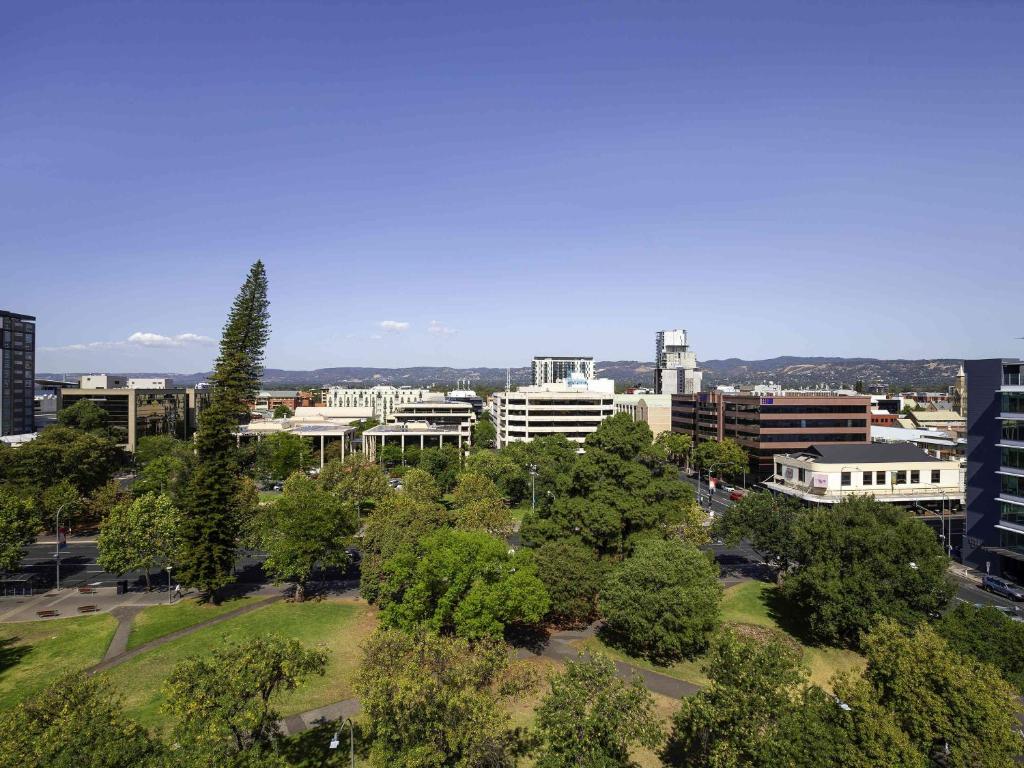 an aerial view of a city with trees and buildings at Mantra Hindmarsh Square in Adelaide