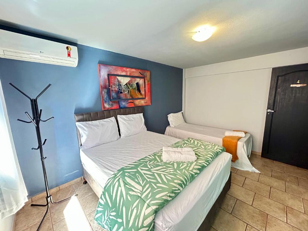 Ένα ή περισσότερα κρεβάτια σε δωμάτιο στο Pousada Recanto das Praias