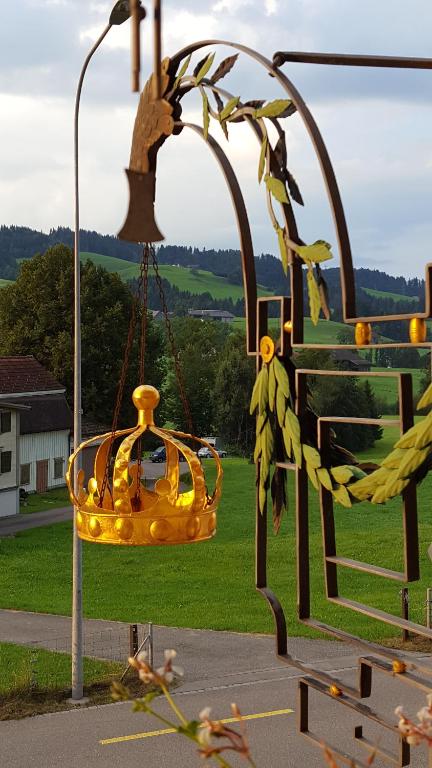 a yellow swing with bananas hanging from a pole at Gästehaus Krone in Schönengrund