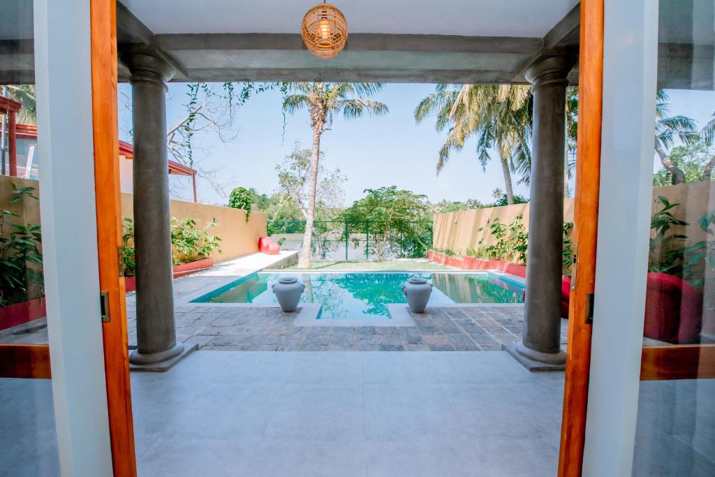 a view of a pool from the door of a house at Sithagi River Front Villa Weligama in Weligama