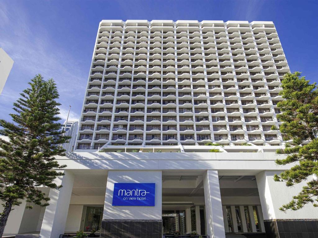 a large white building with a sign in front of it at Mantra on View in Gold Coast