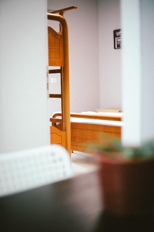 a bedroom with a bunk bed and a chair at N'Baz Apartment - Pedonale, Shkodër in Shkodër
