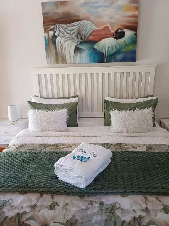 a bedroom with two beds with towels on them at Cosy Stay in Robertson