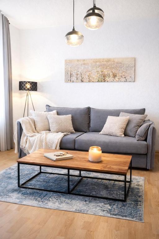 a living room with a couch and a coffee table at N&N Altbau-Apartments Schwerin nähe Schloss & Zentrum in Schwerin