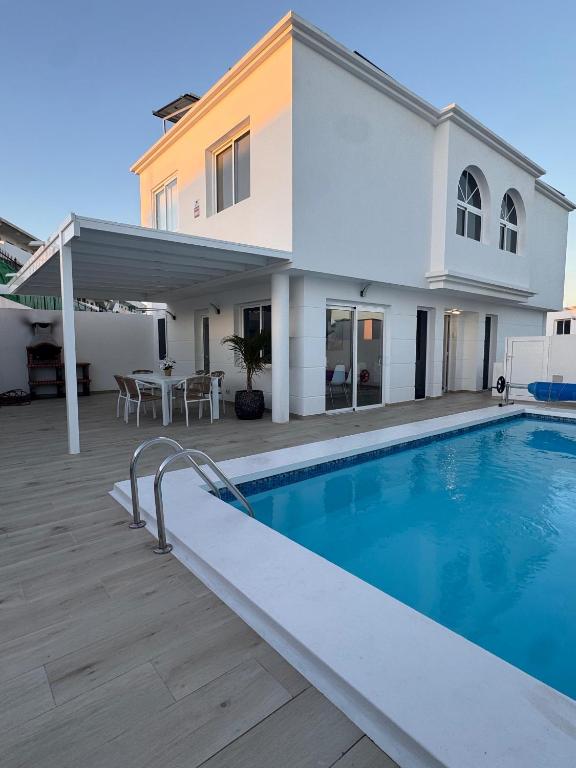 a villa with a swimming pool and a house at Casa Mer in Tías