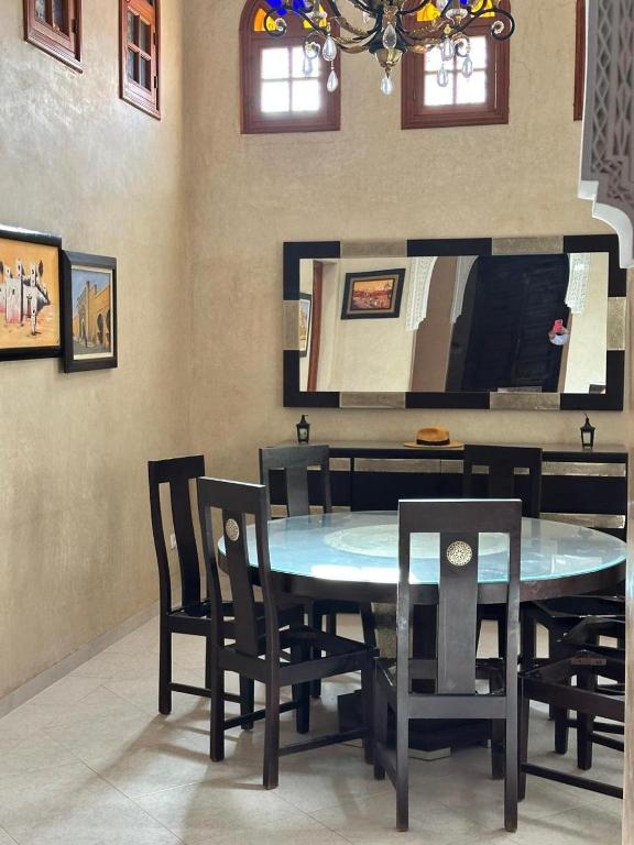 a dining room with a blue table and chairs at Villa Oum Palace in Marrakesh