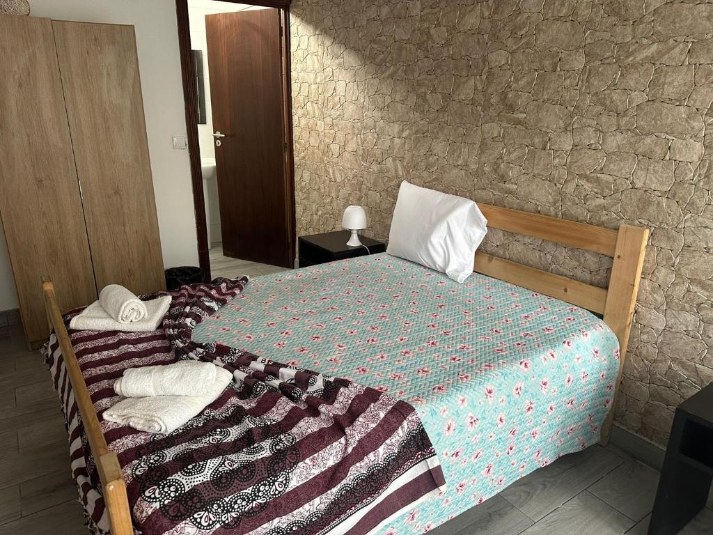 Postel nebo postele na pokoji v ubytování Micaelense Guest House