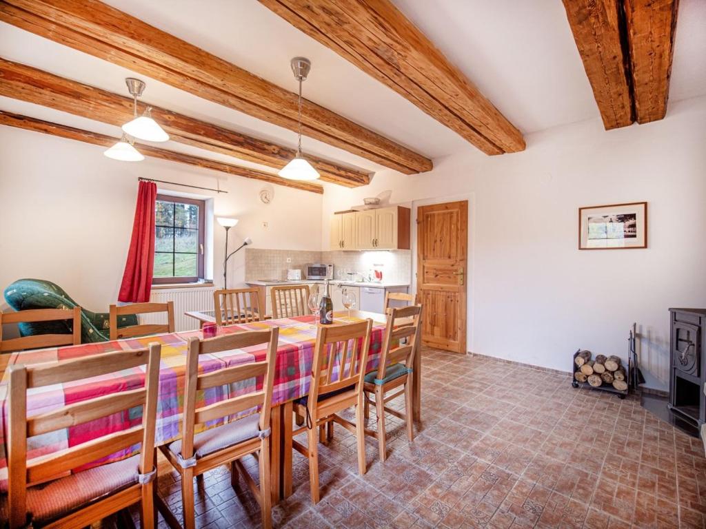 a kitchen and dining room with a table and chairs at Nová Hájovna in Říčky