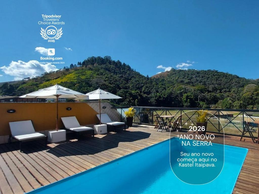 einem Pool mit Stühlen und einem Berg im Hintergrund in der Unterkunft Kastel Itaipava in Itaipava