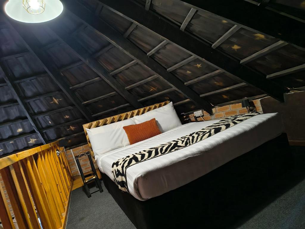 a bed in the middle of a room at Oceans Bavarian Boutique Apartments in Maun