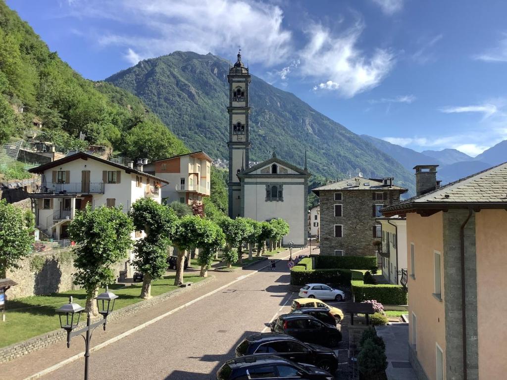 a small town with a clock tower on a street at Fuga dalla città in Grosotto